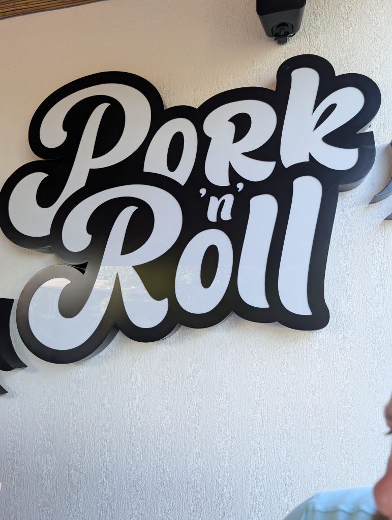 The sign for Pork N Roll restaurants