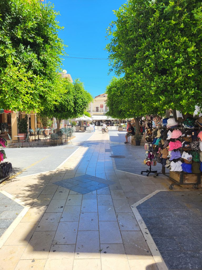 a shopping street lined with trees and a lovely tiles floor in Zante town