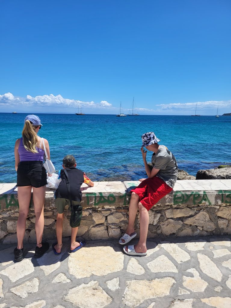 the back of my 3 children looking out to sea in zante town