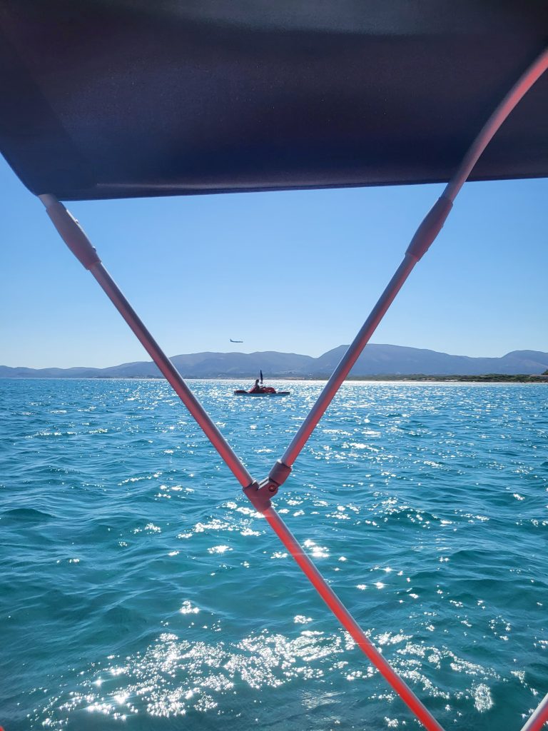 Views of a plane coming in to land from a pedlo out from the shore in Kalamaki