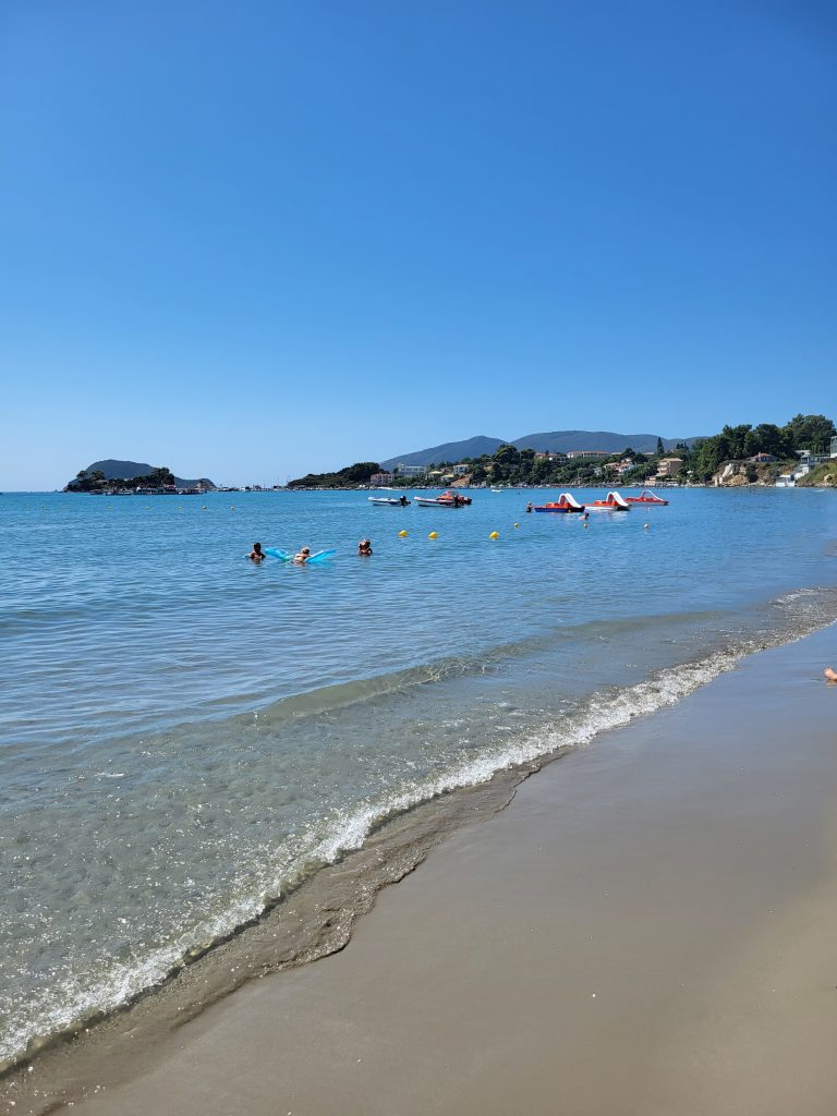 a look down the beach at Laganas with some inflatables in the distance on the water