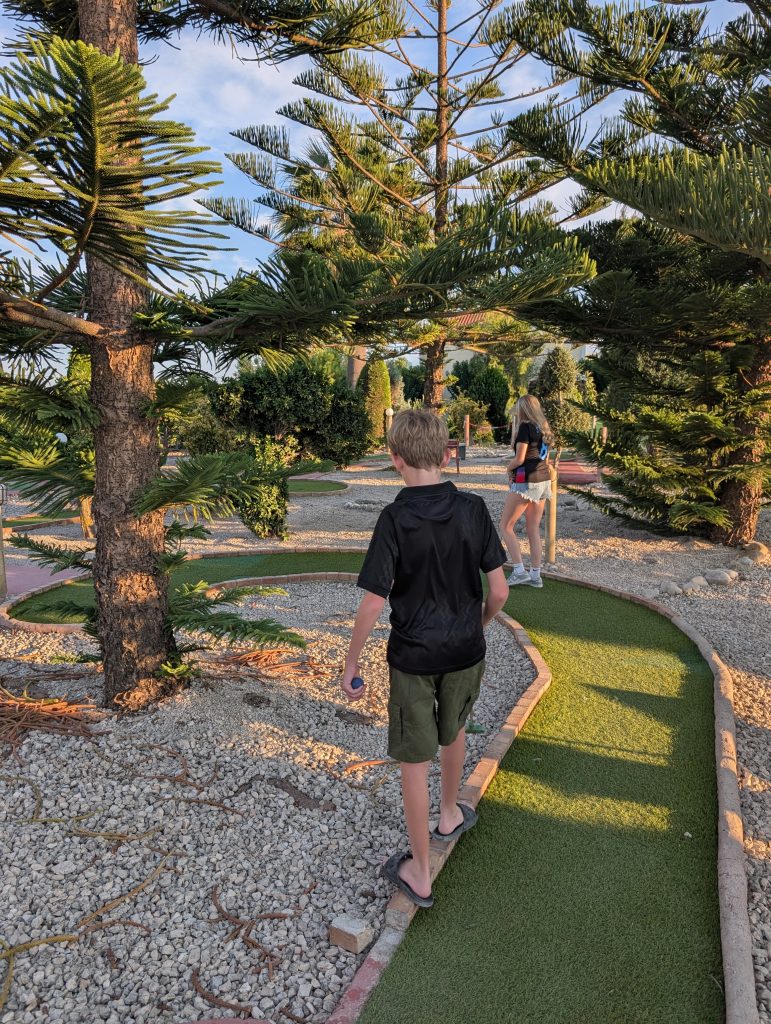 A great teen friendly destination has lots of activities - here pictured are my teens playing crazy golf in zante