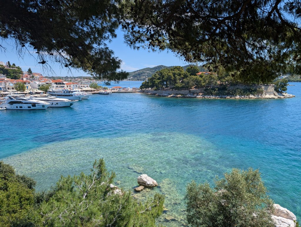 The blue sea with a few yachts moored up at Skiathos Town port
